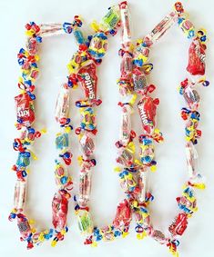 candy bar necklaces laid out in the shape of letters