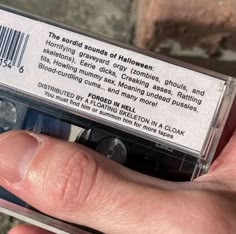 a person holding a cassette in their left hand and the label on it says, the record sounds of halloween