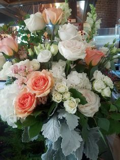 a vase filled with lots of white and pink flowers