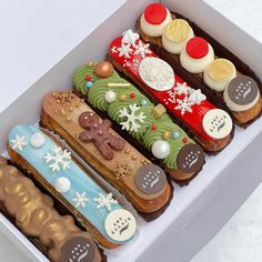 a box filled with lots of different types of decorated pastries on top of each other