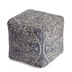 a blue and white square ottoman sitting on top of a floor