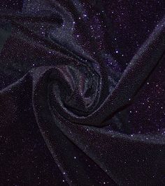 the fabric is shiny and dark purple with small stars on it, as well as glitters