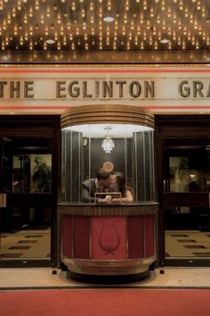 a person taking a photo in front of the egliinton gras