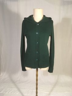 "vintage 1970s button up hooded sweater label- Young East 70% acrylic, 30% wool ,ade in Hong Kong solid forest gren 2 front pockets long sleeves good vintage condition, light wear light pilling,  bottom button missing, can replace, just let me know w/purchase-will not exactly match labeled 11/12-see below measures, lying flat, shoulder-15\" chest-17\" to 21\" sleeve-27\" length-25\"" Vintage Green Long Sleeve Hoodie, Cozy Green Sweater With Buttons, Vintage Green Knit Outerwear, Hooded Sweater With Buttons For Fall, Hooded Button Sweater For Fall, Vintage Hooded Winter Sweater, Casual Hooded Wool Cardigan, Vintage Green Knit Cardigan, Green Vintage Knit Cardigan