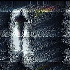 an abstract image of a person standing in the rain with their reflection on the water