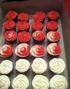 cupcakes with red and white frosting in a box on a table top