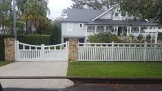 a white picket fence in front of a house