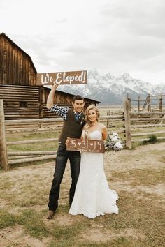 a bride and groom holding up a sign that says we eleped