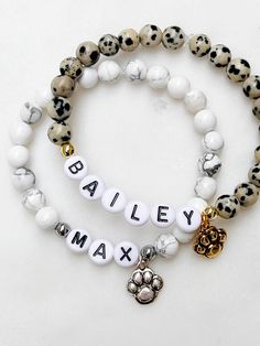 Listing is for one (1) bracelet containing 6mm beads, white/black letter beads, and accented with matching spacer beads and paw print charm.  This bracelet is NOT recommended for pets to wear. This bracelet stretches to fit small to medium sized wrists (approximately 7 inches long). Size customization available free of charge - leave your desired dimensions in the comment section with your order.  Please email me with any questions: sarahndipityjewelry@gmail.com. Personalized White Stretch Bracelet With Round Beads, Personalized White Stretch Bracelet With Custom Name, White Custom Name Stretch Bracelet For Friendship, Personalized White Spiritual Stretch Bracelet, Beaded Bracelets Dog Mom, Beaded Paw Print, Puppy Bracelet, Dalmatian Stone Bracelet, Dog Bracelet