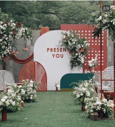 an outdoor ceremony set up with white flowers and greenery