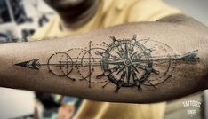 a man with a compass tattoo on his arm