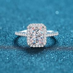 a cushion cut diamond ring on a blue background