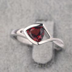 Ring details metal: silver/14k white(rose/yellow) gold center stone: trillion shape 6*6mm (0.93ct) garnet accent stone: cz NOTE: if it is silver or white gold, it will be get plated with rhodium Customization is available you can change, add or remove any parts of the ring if you have good idea. I can add special engraving inside the shank of the ring by free (words, date, simply simbles and so on) too. I am happy to help out or make any adjustments to your order if you have a special request. P Formal Trillion-cut Birthstone Ring, Trillion Cut Birthstone Ring For Formal Events, Trillion Cut Birthstone Ring For Promise, Elegant Triangle Rings For Anniversary, Formal Trillion Cut Birthstone Ring, Trillion Cut Birthstone Promise Ring, Elegant Trillion Cut Birthstone Rings, Silver Trillion-cut Birthstone Ring, Silver Trillion Cut Birthstone Ring