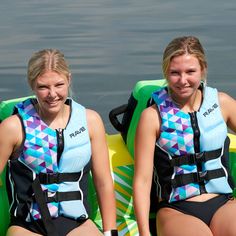 two women sitting on inflatable rafts next to each other