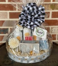 a basket filled with lots of items sitting on top of a wooden table next to a brick wall