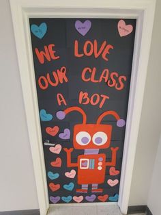 a door decorated to look like a robot with words written on it that say we love our class a bot