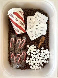 a tray filled with candy, candies and playing cards on top of chocolate chips