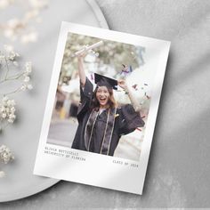 a graduation photo on a plate next to flowers