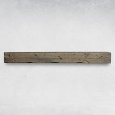 a piece of wood sitting on top of a white wall