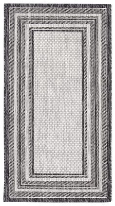 a black and white rug with an area rug in the middle on top of it