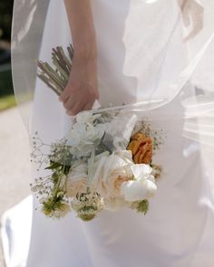 a bride holding a bouquet of flowers in her hand