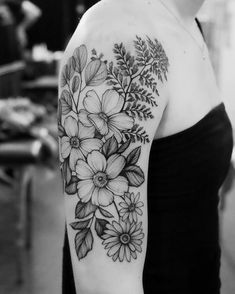 a woman with a flower tattoo on her arm