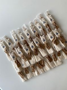 several pairs of shoes are lined up on a white tablecloth with lace and beads