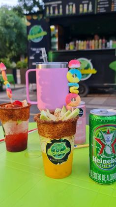 there are three drinks on the table with donuts in cups next to each other