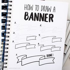 a spiral notebook with how to draw a banner on it