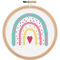 a cross stitch rainbow with a heart in the middle