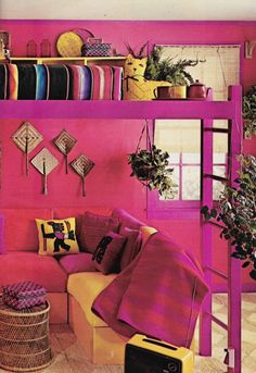 a living room filled with furniture and lots of colorful items on top of a shelf