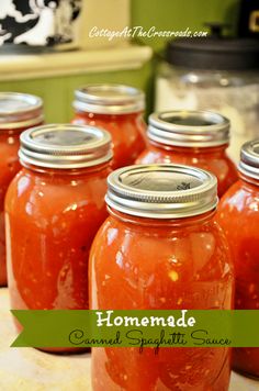 several jars filled with homemade tomato sauce on top of a kitchen counter next to an oven