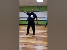 a man standing on top of a hard wood floor