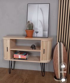 a wooden shelf with some books and a potted plant