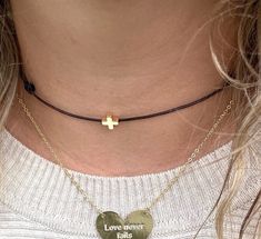 This dainty and minimalist choker necklace features a dainty tiny gold cross charm that adds a touch of spirituality to your outfit.  This choker is delicate and comfortable to wear.  You will look adorable wearing this tiny necklace. The cute necklace you'll never want to take off. This cross choker makes a meaningful gift for a loved one or a cherished addition to your own jewelry collection.  Perfect as a layering necklace. ♥ ITEM DETAILS: Total length: The size of the necklace is ADJUSTABLE.  Materials: Waxed Cord Necklace. Gold Plated Tiny Cross.  Waxed Cord Available: Black - Dark Brown - Light Brown - Turquoise - Peach - Baby Blue -  Hot Pink - Beige - Khaki - Baby Pink - Green - Orange - Yellow - Lilac - Red. Waxed Cord Size: 1mm waxed cord.  ♥ GIFT IT Jewelry comes in a cute bag r Adjustable Dainty Choker As A Gift, Dainty Adjustable Clavicle Chain Choker, Delicate Adjustable Everyday Choker, Dainty Adjustable Choker, Delicate Adjustable Choker Charm Necklaces, Adjustable Delicate Chain Choker Charm Necklaces, Adjustable Delicate Chain Charm Choker, Simple Adjustable Choker Jewelry, Gold Resizable Choker As Gift