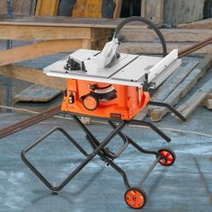 an orange table saw sitting on top of a metal cart