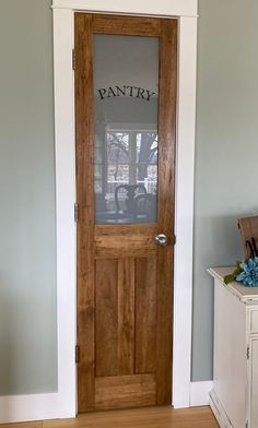 a wooden door with the word pantry written on it