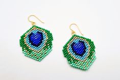 green and blue beaded earrings on white background