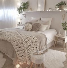 a bed with white blankets and pillows on top of it