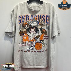 Vintage Ncaa Syracuse Orange Looney Tunes Shirt, Syracuse Orange Shirt, Syracuse University, Unisex T-Shirt Sweatshirt Hoodie, Vintage Shirt Our Classic T-Shirt Serves As The Perfect Short-Sleeved Shirt For Your Unique, Funny, Or Personalized Designs. Brand: Gildan Heavy Weight Fabric Classic Unisex Makes This An Easy Fit Size Up If You Want Something Roomier Our Shirts Materials: 100% Cotton ** Note: - Double Check Your Address Before Ordering. - If You Want To Return The Goods, You Are The One Looney Tunes Shirt, Syracuse University, University Shirt, Orange Shirt, Vintage Shirt, Looney Tunes, Cool Tees, Sports Shirts, Sweatshirt Hoodie