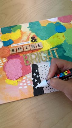 someone is painting on a piece of art with crayons and glue, along with the words shine bright