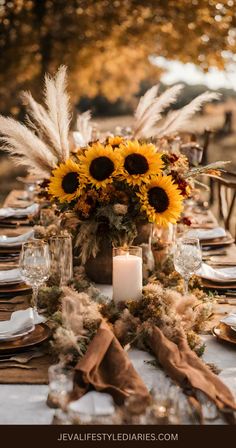 a table set with sunflowers, candles and napkins for an autumn wedding