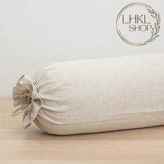 a pillow with a bow on it sitting on a wooden floor