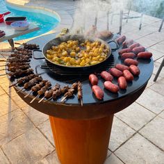 an outdoor bbq grill with various foods cooking on it