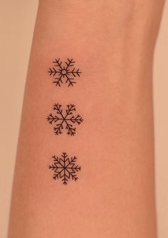 three snowflakes tattoo on the arm