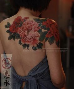 the back of a woman's body with flowers on it