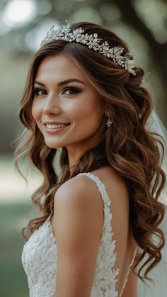 a woman wearing a wedding dress and a tiara with flowers on her head is smiling at the camera