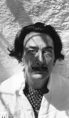 a black and white photo of a man with a fake moustache on his face