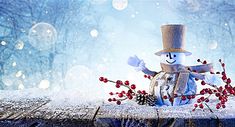 a snowman sitting on top of a wooden table next to berries and pine cones