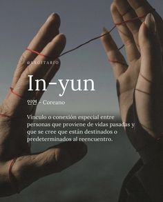 two hands with red string in front of the words in - yun written below